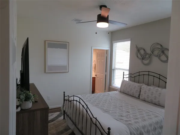 a bedroom with a bed and a chandelier