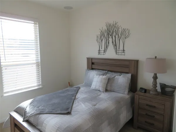 a bedroom with a bed and a window