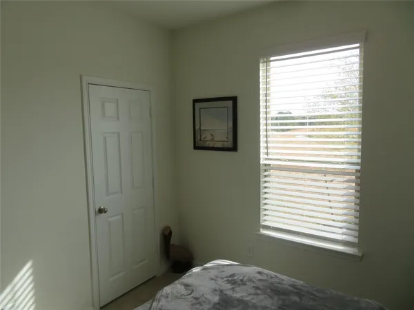 a view of a bedroom that has a window in it
