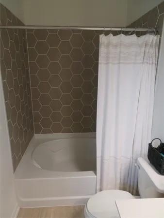 a bathroom with a bathtub and shower