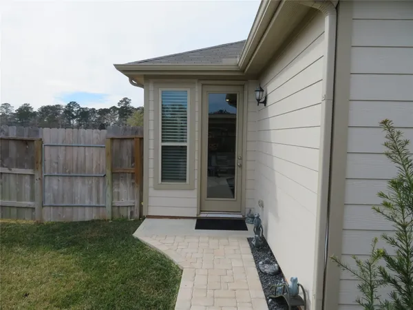 a pathway of a house with a yard