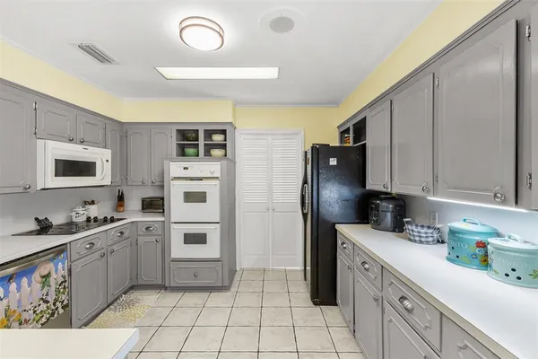 a kitchen with a sink cabinets and stainless steel appliances