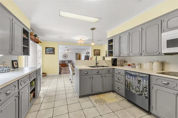 a kitchen with a sink window and cabinets
