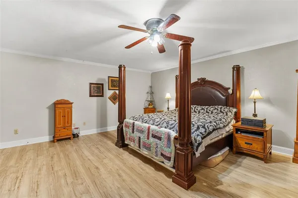 a bedroom with bed and wooden floor