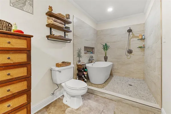 a white toilet sitting next to a bathroom sink