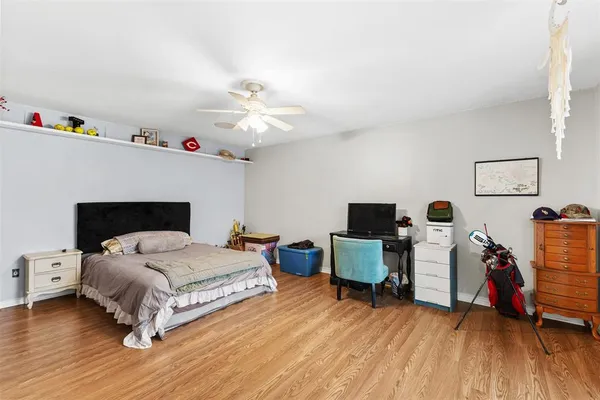 a bedroom with a bed and a wooden floor