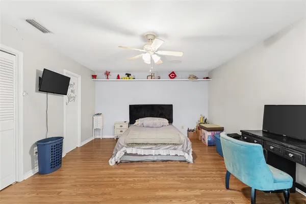 a living room with furniture a flat screen tv and a table