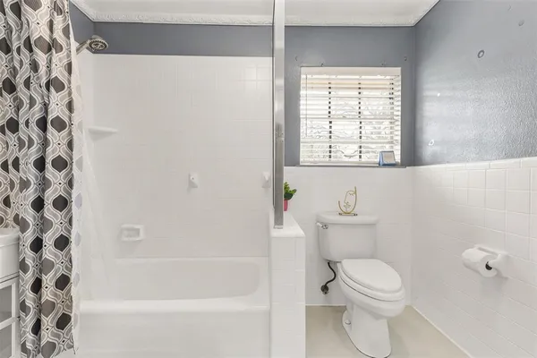 a bathroom with a toilet and a bathtub