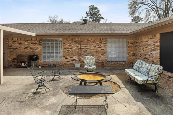 a building outdoor space with patio furniture and potted plants