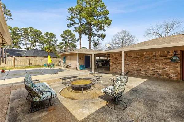 a view of a house with swimming pool and sitting area