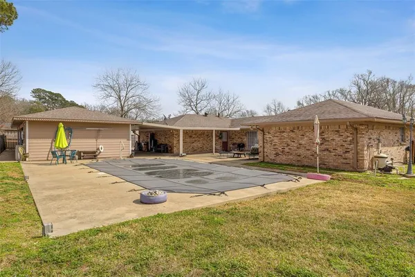 a view of a house with a yard and sitting area