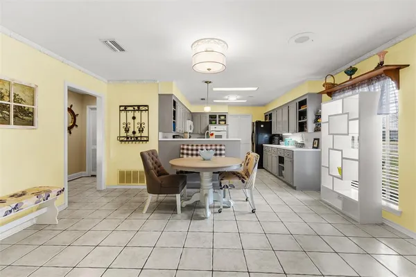 a view of a dining room with furniture and chandelier