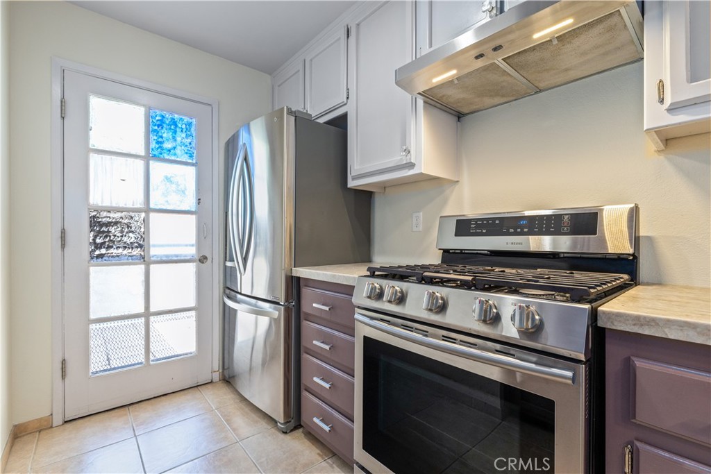 a kitchen with stainless steel appliances and cabinets