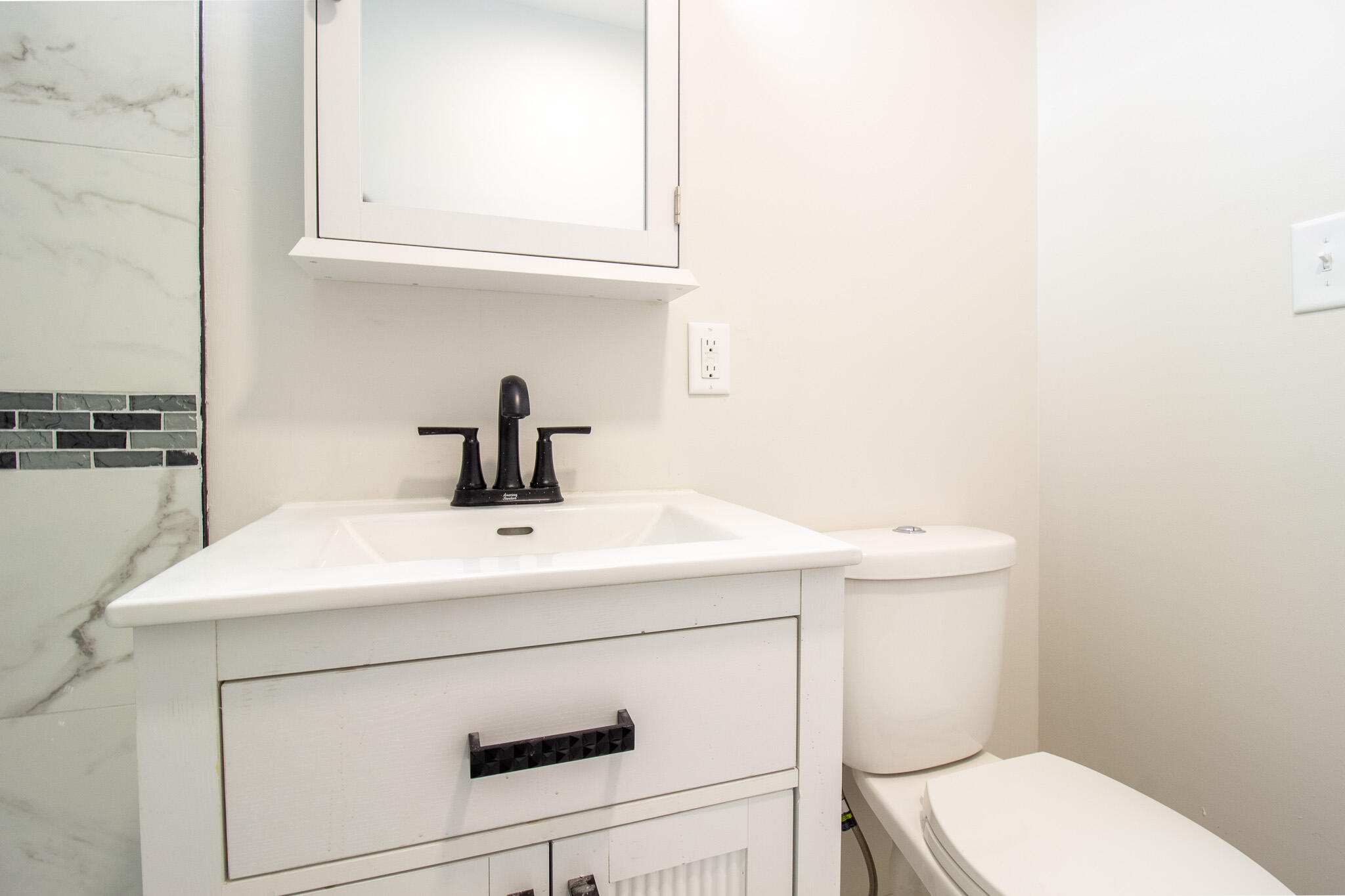 1755 Ralston Street Gary, IN 46406 - Photo 16 of 29 a bathroom with a sink a toilet and vanity