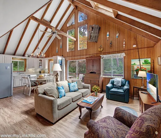 a living room with furniture a fireplace and a table