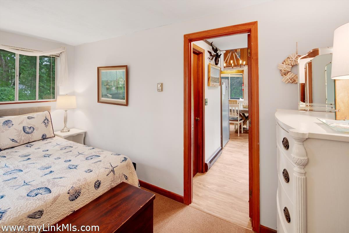 9 Galway Road Vineyard Haven, MA 02568 - Photo 17 of 26 a bedroom with a bed and a mirror