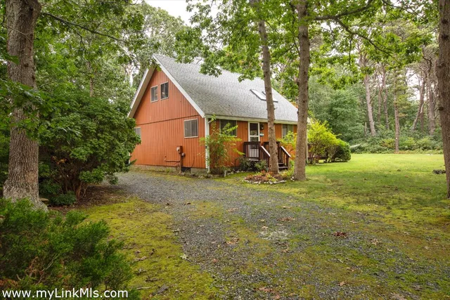 a view of backyard of house with green space