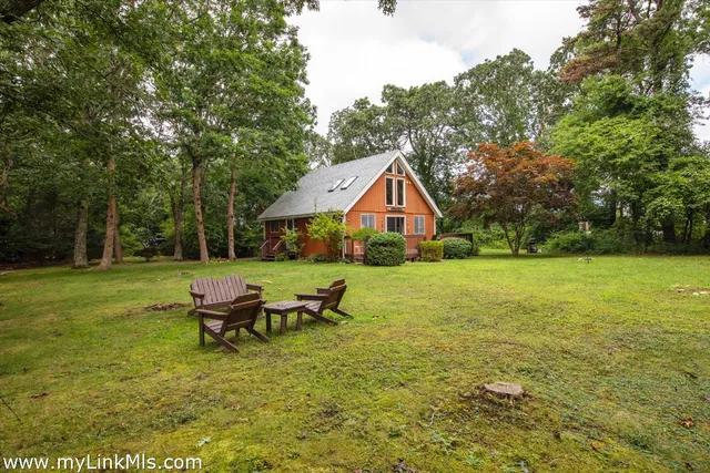a view of an house with backyard space and garden
