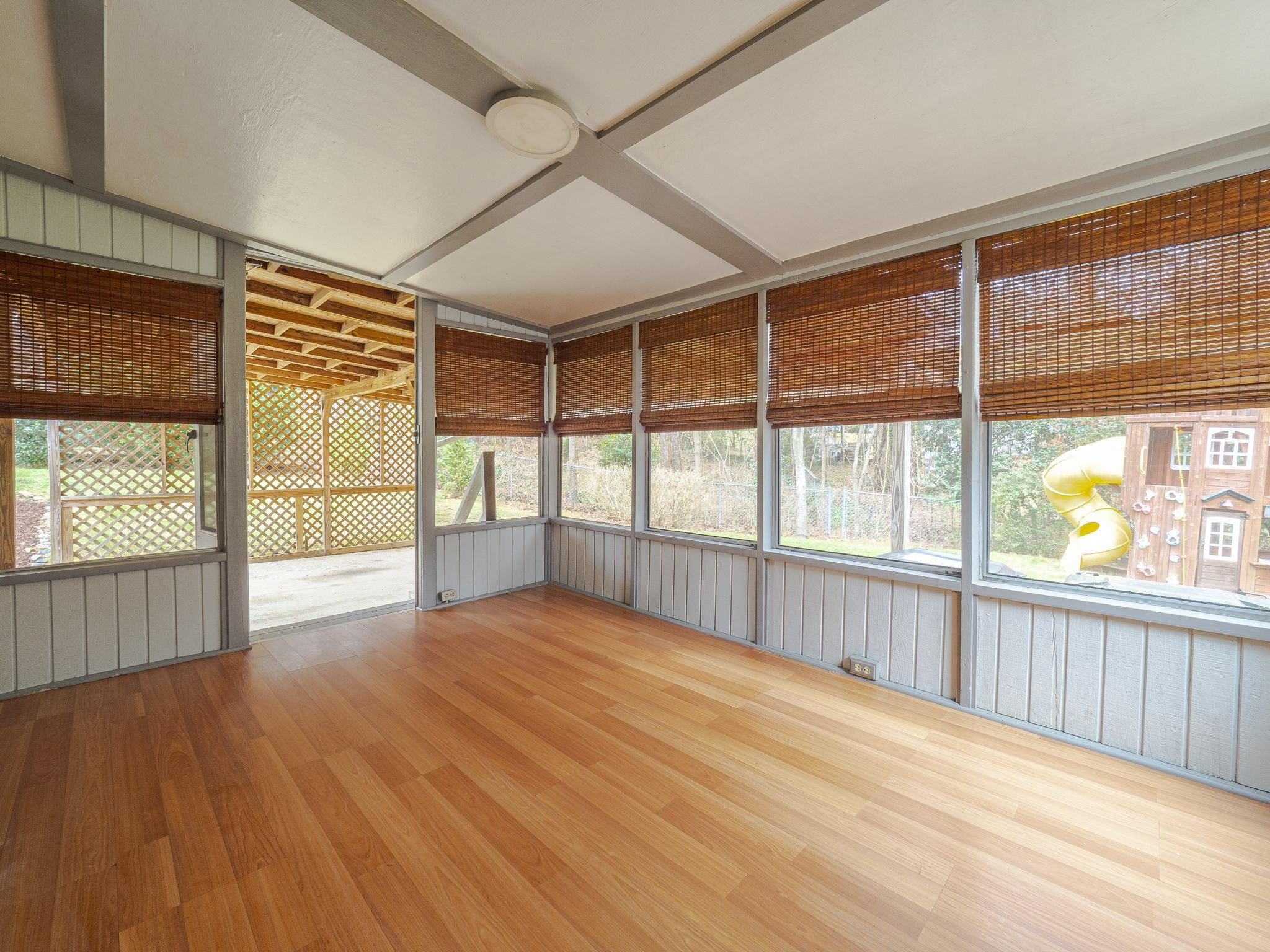 5913 Pine Tree Court Raleigh, NC 27609 - Photo 17 of 19 This AWESOME space can be used during much of the year & leads to the covered carport on one side & a BIG DECK/backyard on the other side! Laminate flooring is easy to maintain/clean! 3 Seasons Room