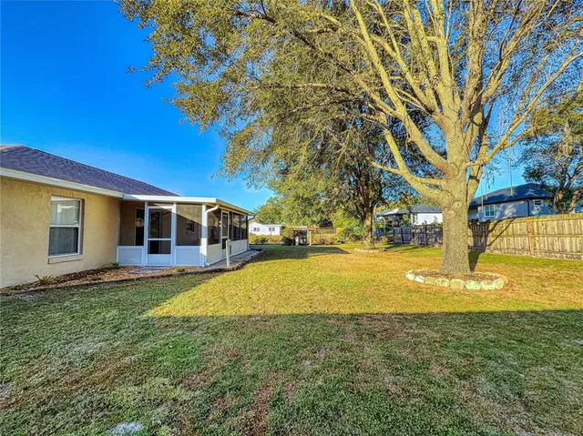a view of a patio with table and chairs and potted plants