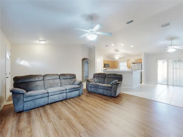 a kitchen with kitchen island a sink stainless steel appliances and cabinets