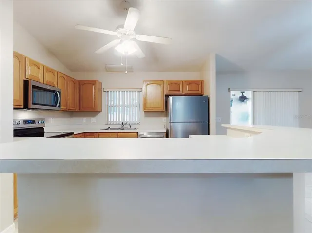 a kitchen with stainless steel appliances granite countertop a refrigerator sink and stove