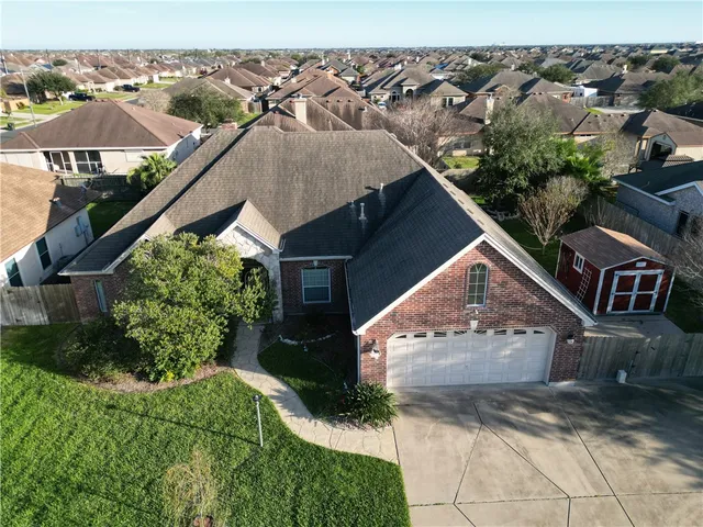 an aerial view of a house with a yard