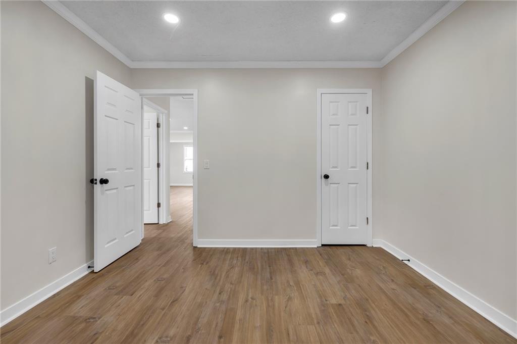 2060 Baker Road Northwest Atlanta, GA 30318 - Photo 11 of 24 an empty room with wooden floor