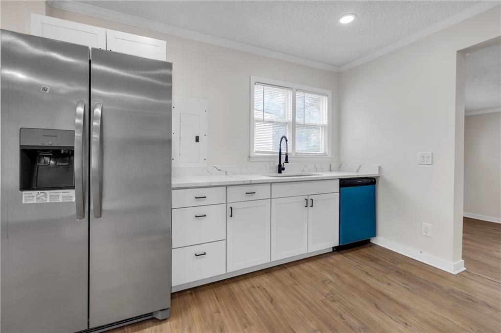 2060 Baker Road Northwest Atlanta, GA 30318 - Photo 13 of 24 a kitchen with a refrigerator sink and cabinets