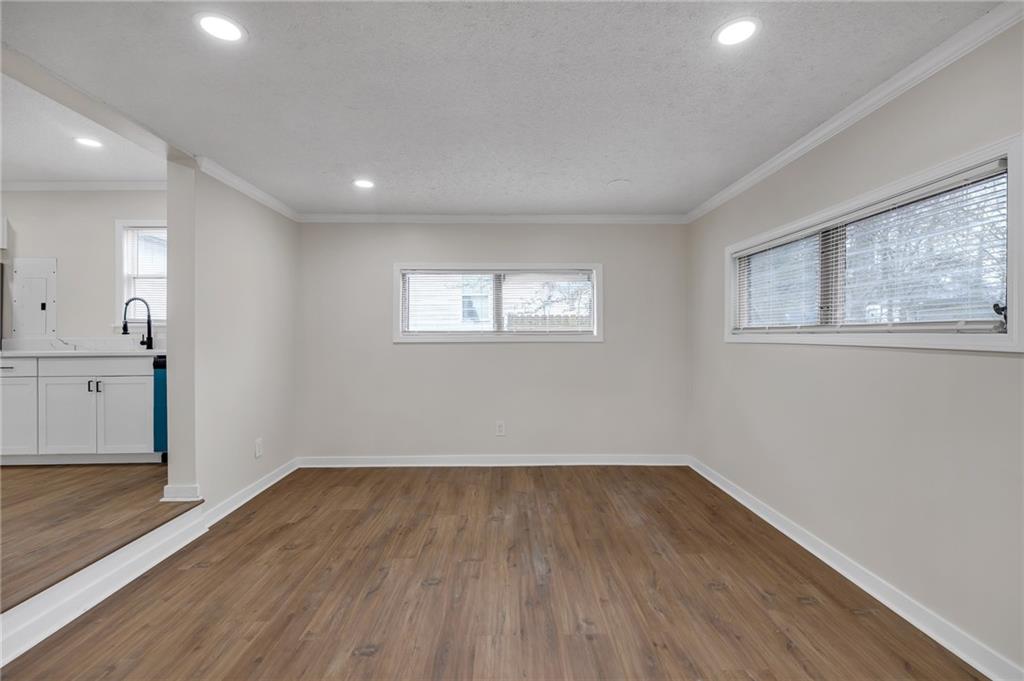 2060 Baker Road Northwest Atlanta, GA 30318 - Photo 17 of 24 wooden floor in an empty room with a window