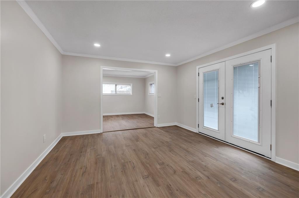 2060 Baker Road Northwest Atlanta, GA 30318 - Photo 18 of 24 an empty room with wooden floor and windows