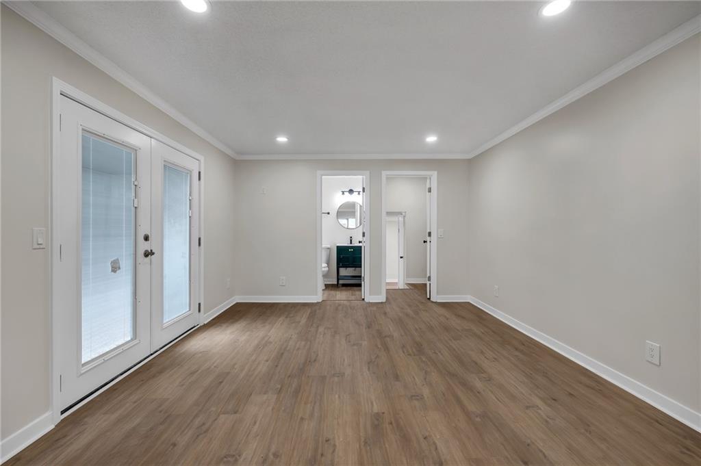 2060 Baker Road Northwest Atlanta, GA 30318 - Photo 19 of 24 wooden floor in an empty room with a window
