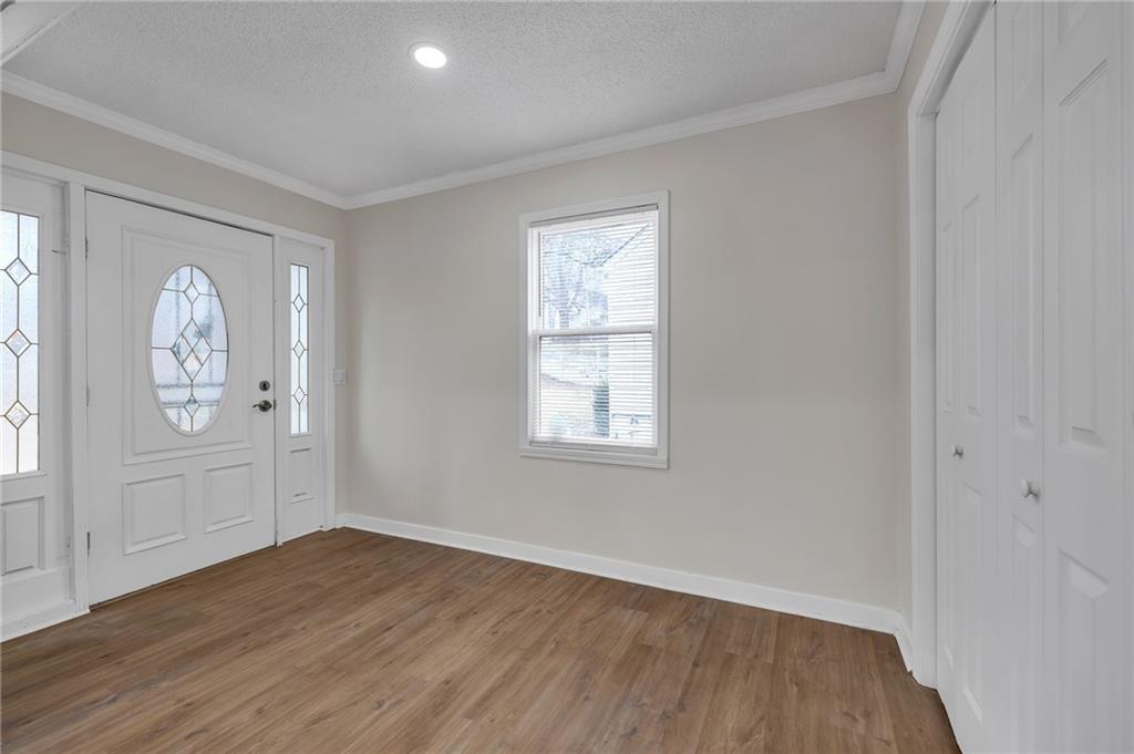 2060 Baker Road Northwest Atlanta, GA 30318 - Photo 2 of 24 an empty room with window and wooden floor