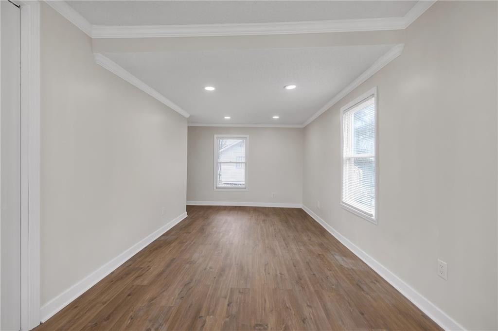 2060 Baker Road Northwest Atlanta, GA 30318 - Photo 23 of 24 an empty room with wooden floor and windows