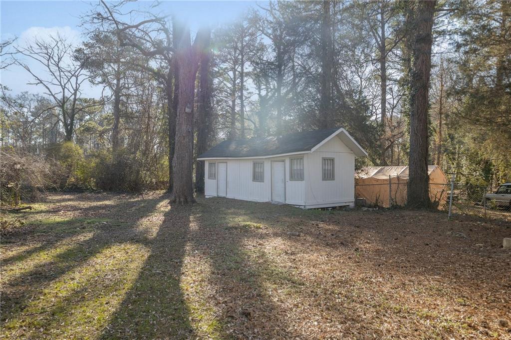 2060 Baker Road Northwest Atlanta, GA 30318 - Photo 24 of 24 a view of a house with a yard covered in snow