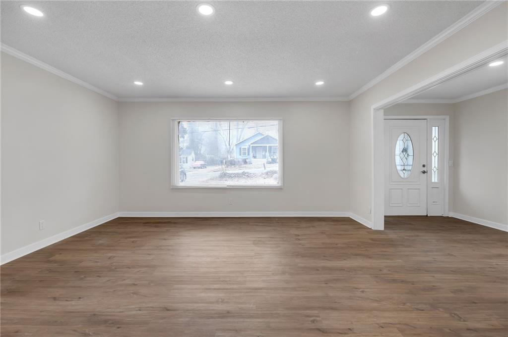 2060 Baker Road Northwest Atlanta, GA 30318 - Photo 4 of 24 an empty room with wooden floor and windows