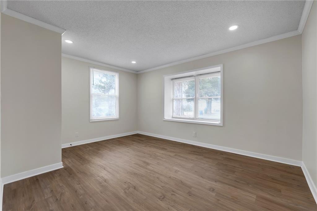 2060 Baker Road Northwest Atlanta, GA 30318 - Photo 8 of 24 an empty room with wooden floor and windows
