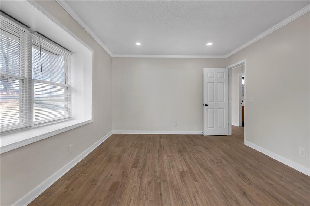 2060 Baker Road Northwest Atlanta, GA 30318 - Photo 9 of 24 a view of an empty room with wooden floor and a window
