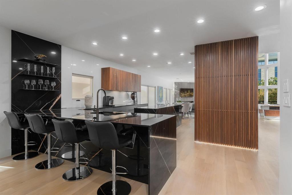 3731 Gilbert Avenue, Unit 3 Dallas, TX 75219 - Photo 12 of 40 a kitchen with stainless steel appliances kitchen island granite countertop a sink and cabinets