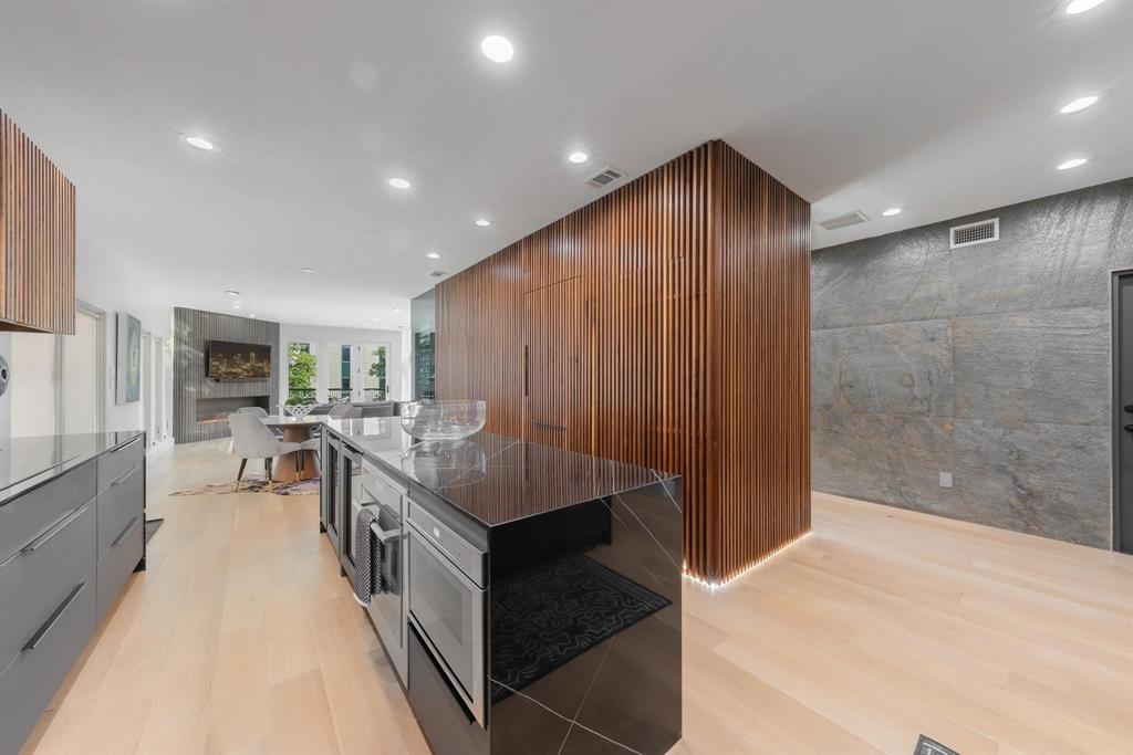 3731 Gilbert Avenue, Unit 3 Dallas, TX 75219 - Photo 13 of 40 a kitchen with stainless steel appliances a stove and more cabinets