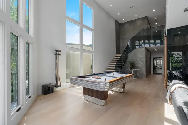 a room with pool table and flat screen tv