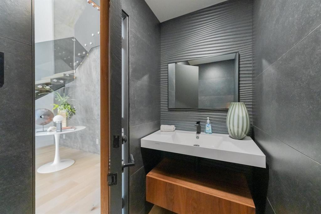 3731 Gilbert Avenue, Unit 3 Dallas, TX 75219 - Photo 23 of 40 a bathroom with a sink and a mirror