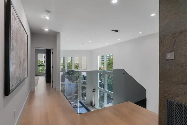 a spacious bedroom with a large bed and a flat tv screen