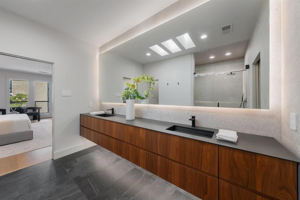 3731 Gilbert Avenue, Unit 3 Dallas, TX 75219 - Photo 32 of 40 a large bathroom with a large mirror vanity and sink