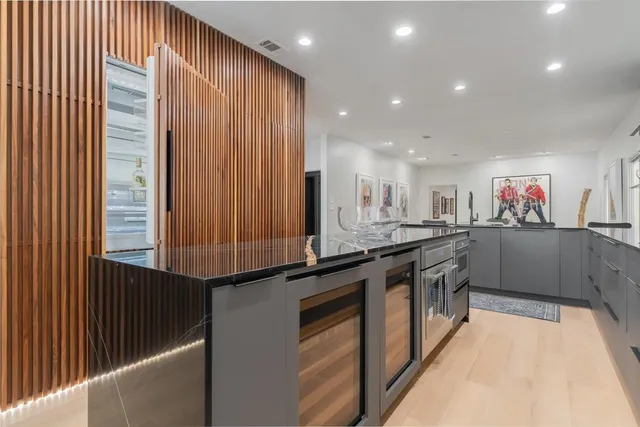 a kitchen with stainless steel appliances granite countertop a sink and a stove