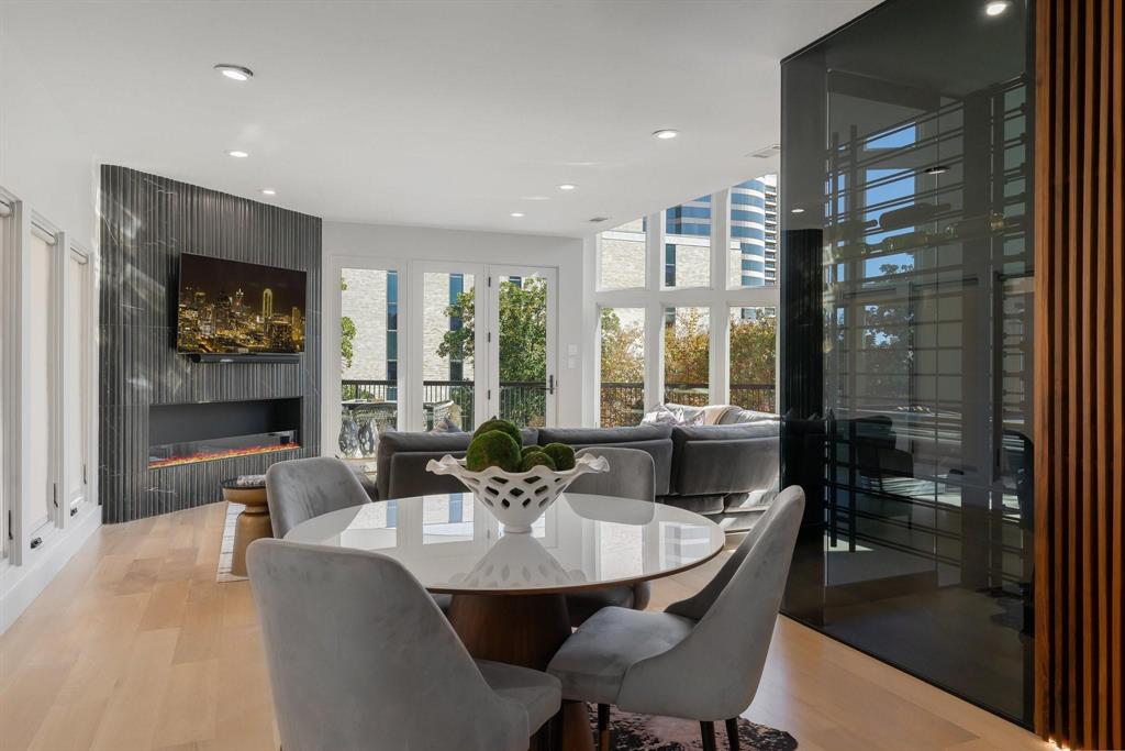 3731 Gilbert Avenue, Unit 3 Dallas, TX 75219 - Photo 9 of 40 a dining room with furniture a large window and a chandelier