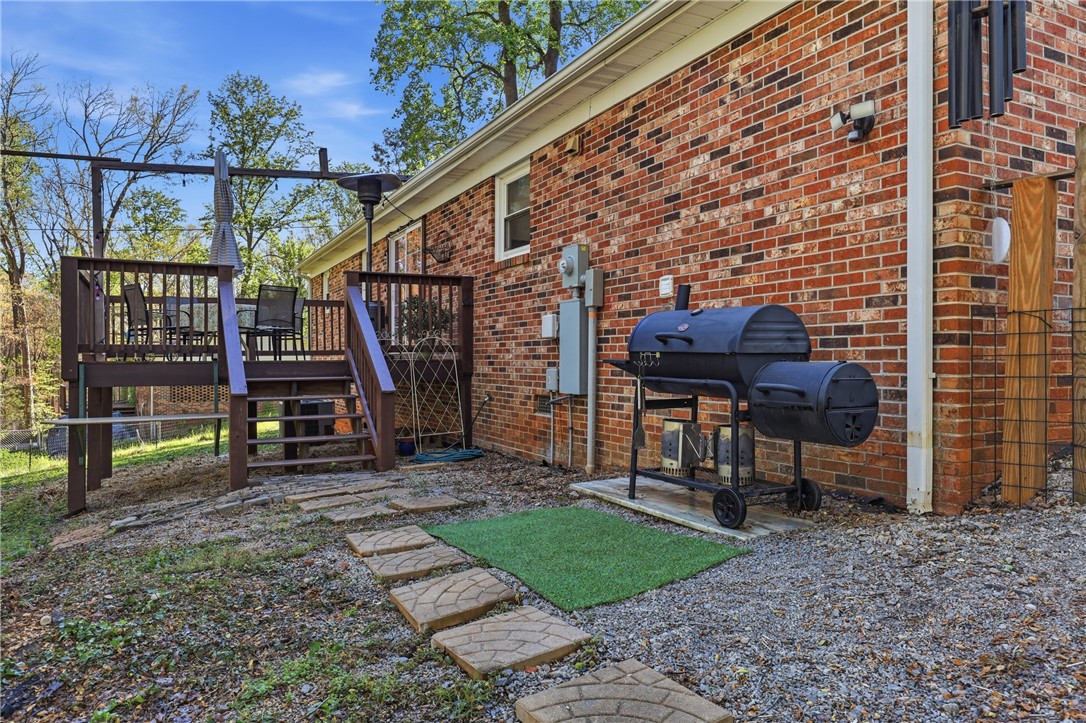 623 West Springwood Drive Seneca, SC 29672 - Photo 24 of 50 This inviting outdoor space features a wooden deck and a brick exterior, perfect for entertaining.