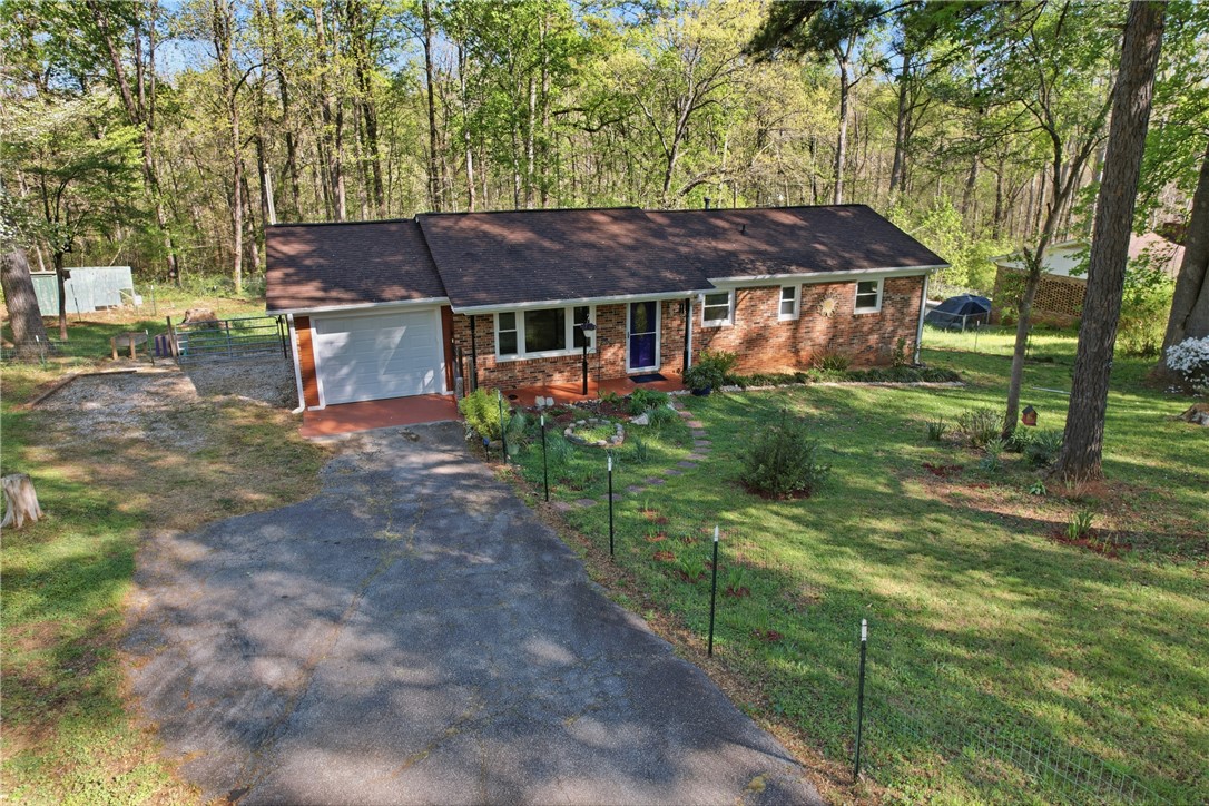 623 West Springwood Drive Seneca, SC 29672 - Photo 27 of 50 This charming home offers a serene escape with mature trees and a welcoming presence.
