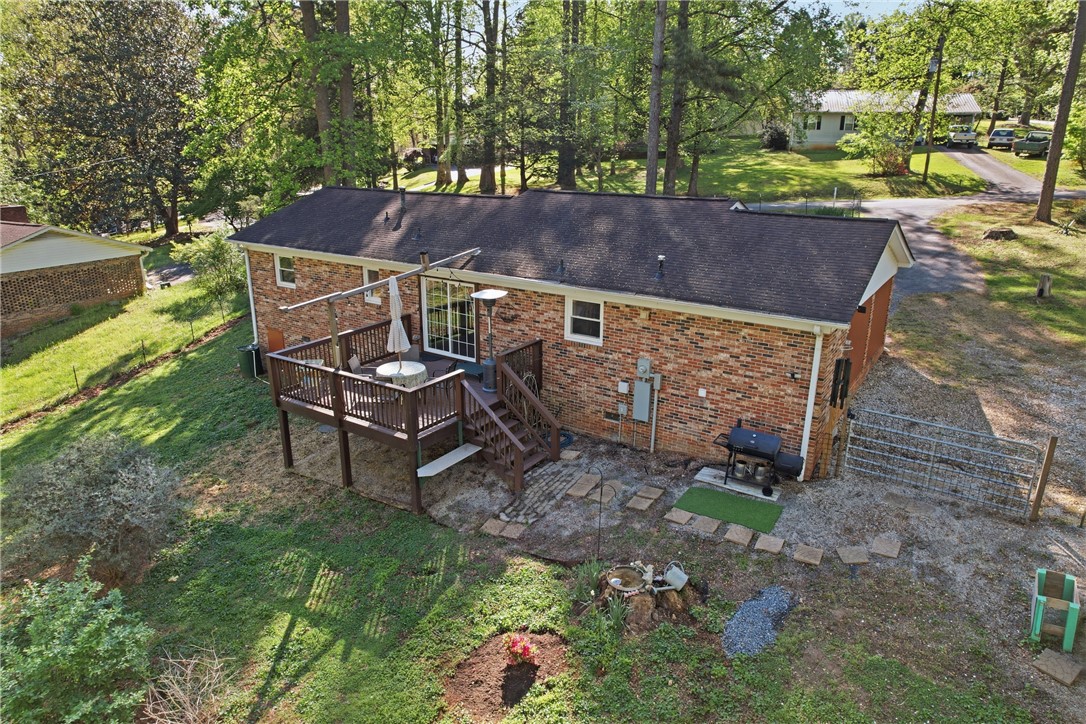 623 West Springwood Drive Seneca, SC 29672 - Photo 28 of 50 An inviting outdoor deck and patio area provides perfect spaces for relaxation and entertaining.