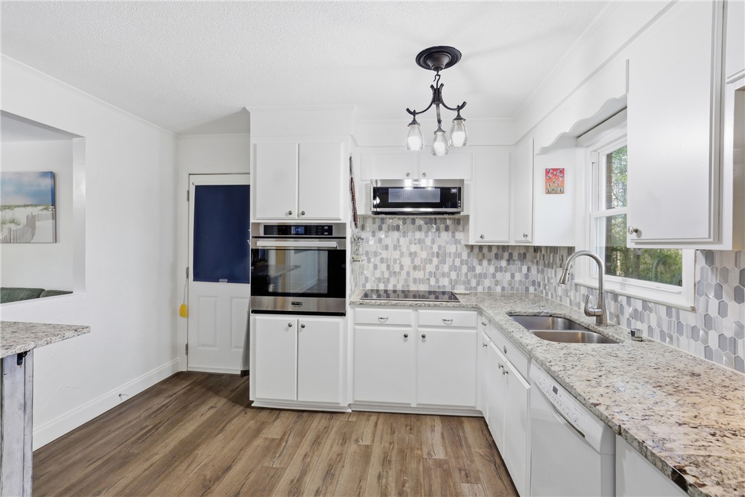 623 West Springwood Drive Seneca, SC 29672 - Photo 38 of 50 This modern kitchen features gleaming countertops, sleek appliances, and ample cabinetry, ideal for culinary creations.